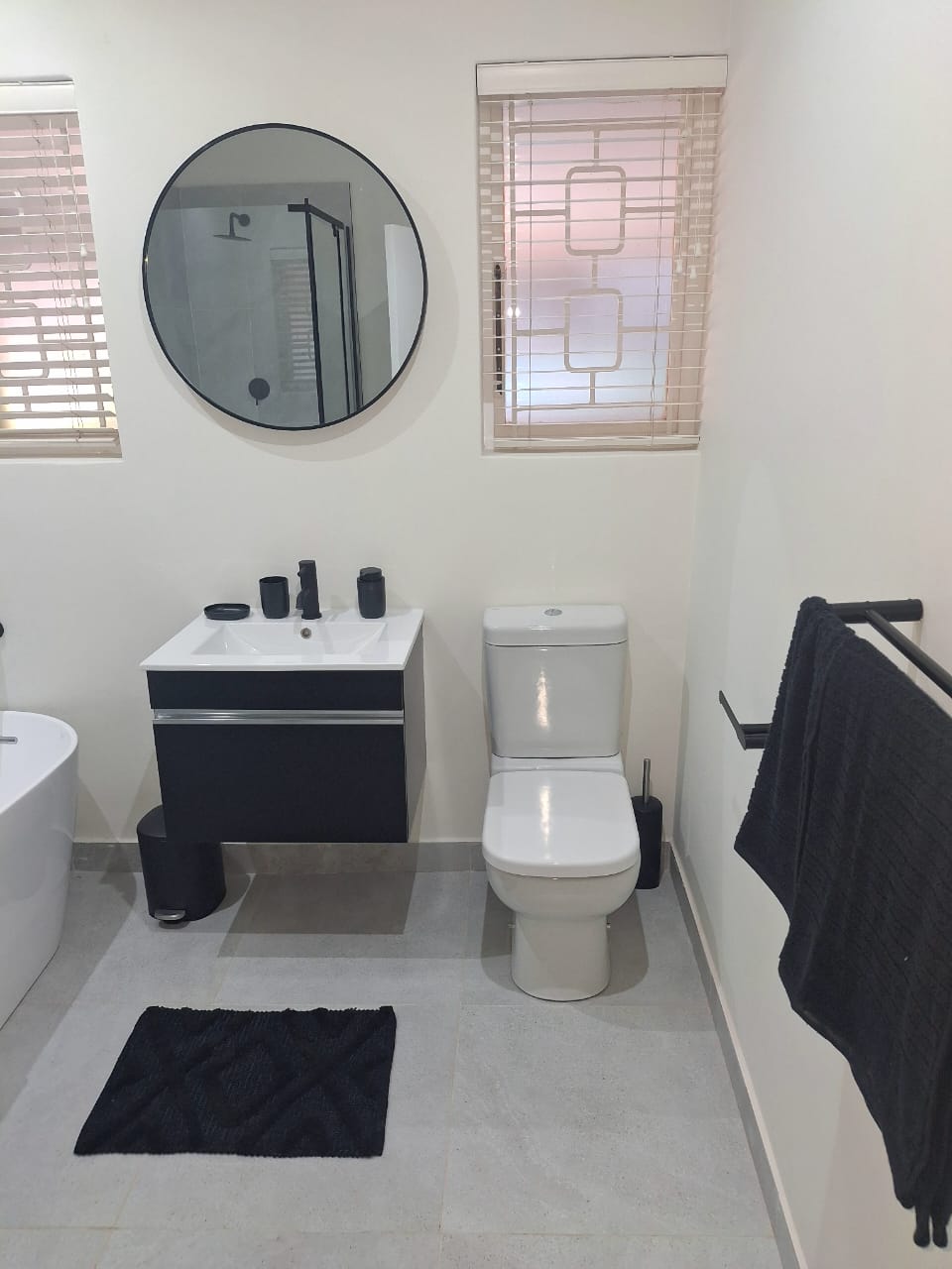 Modern vanity and toilet with black fittings, Durban